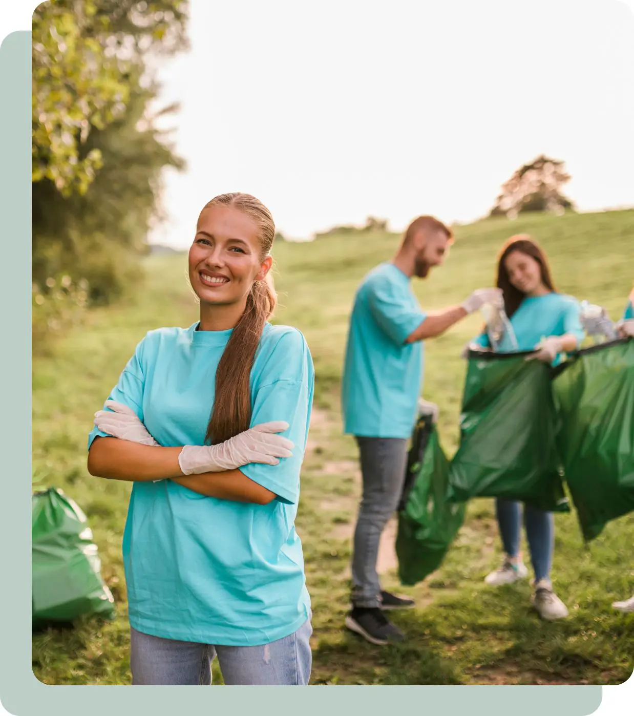 Smiling volunteer cleaning up park.